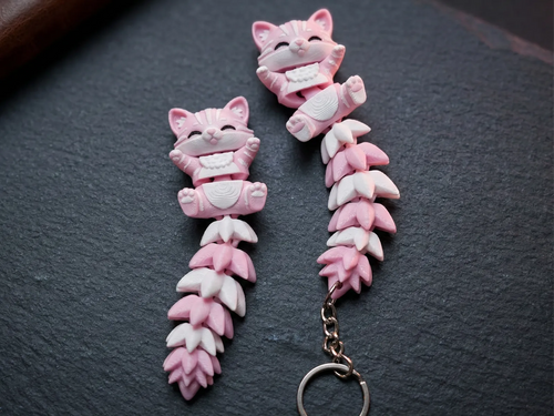 Pink and white flexi cat, as a toy and as a keychain