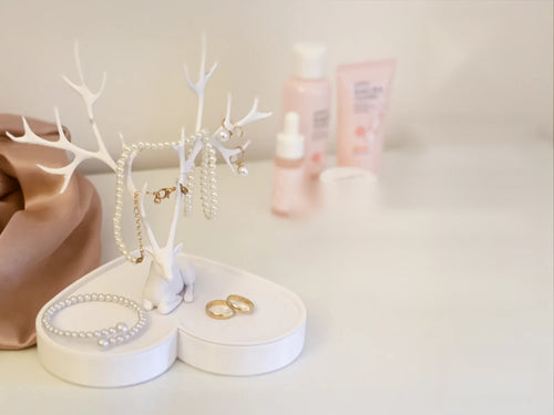 Deer jewelry holder on a heart tray with pearls and rings