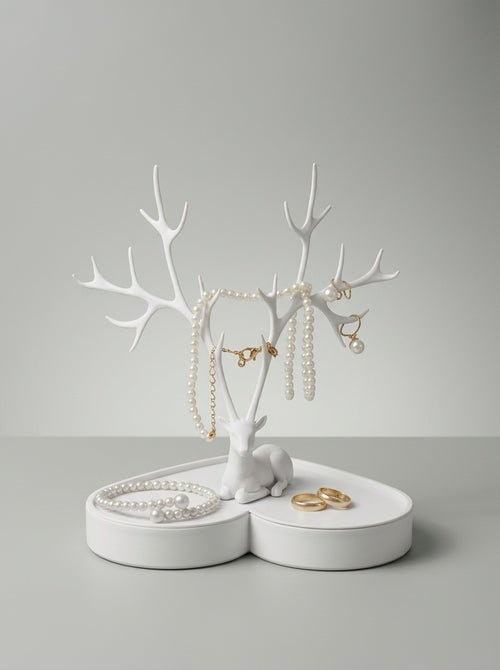 White deer jewelry holder on a heart tray with pearls and rings