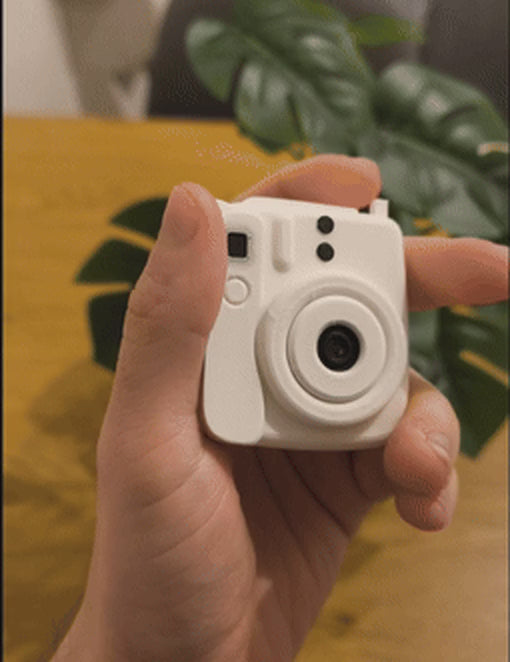 Pressing the button to push the photo out