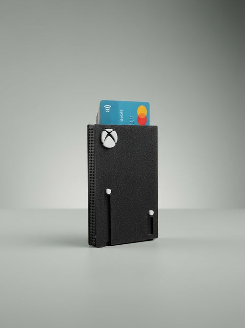 Black Xbox card holder with a bank card sticking out
